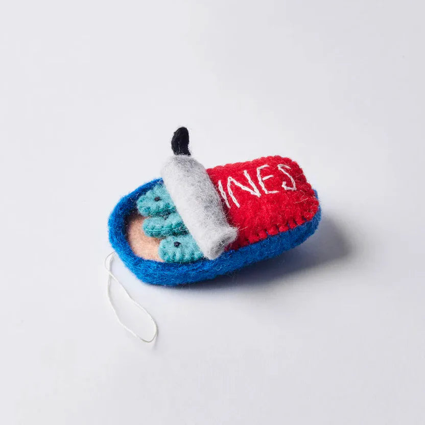 Side view of felt ornament of a can of sardines half open showing three fish.