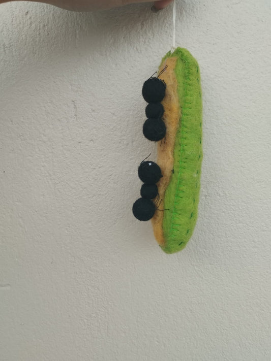Felt ornament of Ants on a Log snack of celery with peanut butter and raisins on top.