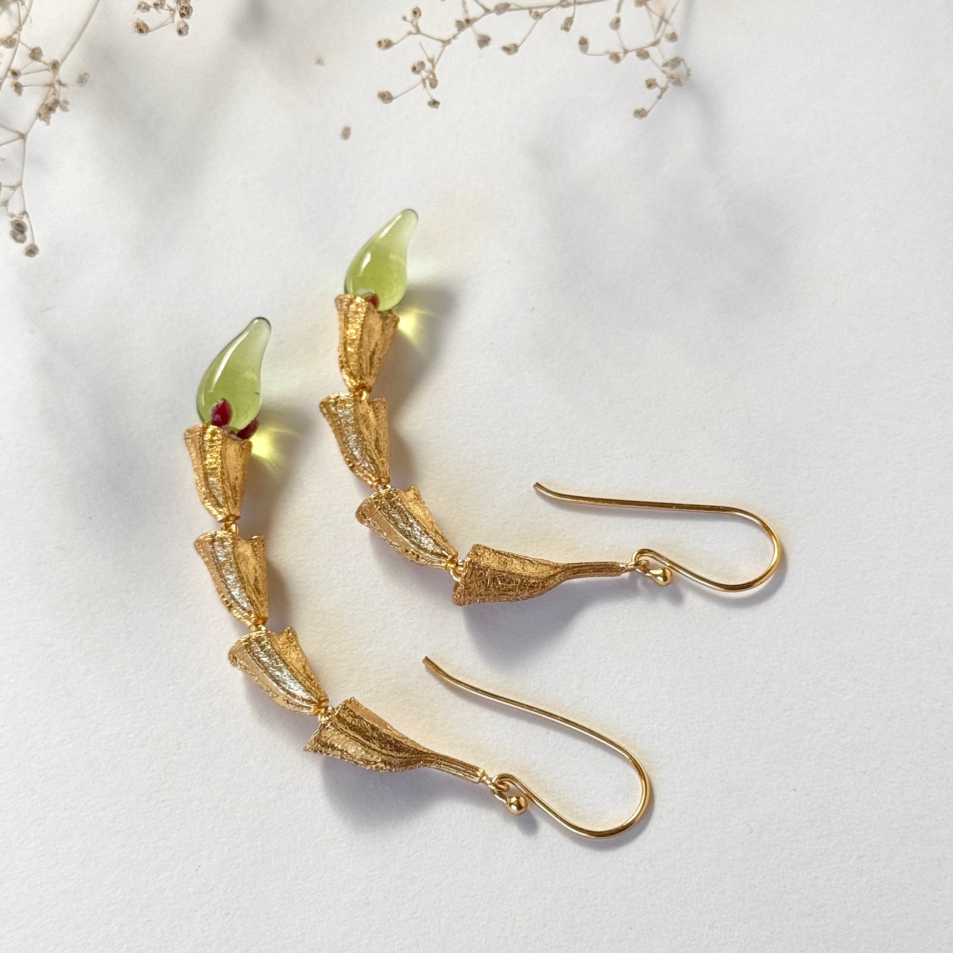 Pair of red and gold chili pod earrings with gold plated findings.