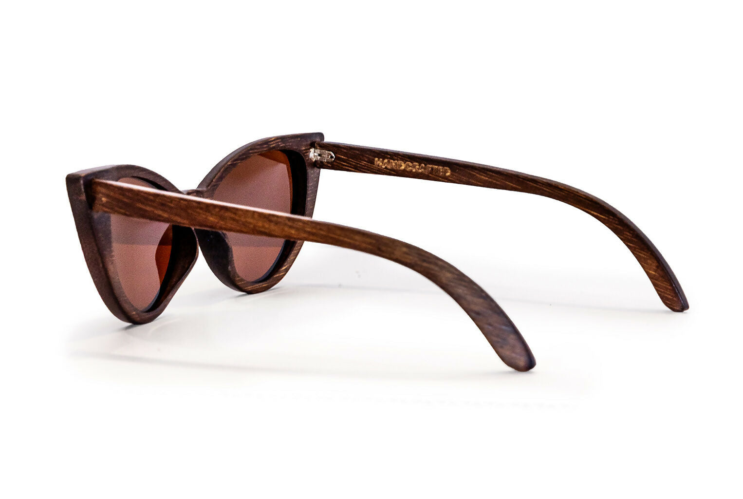 Back diagonal view of bamboo frame cat eye sunglasses with dark brown frame and lenses.