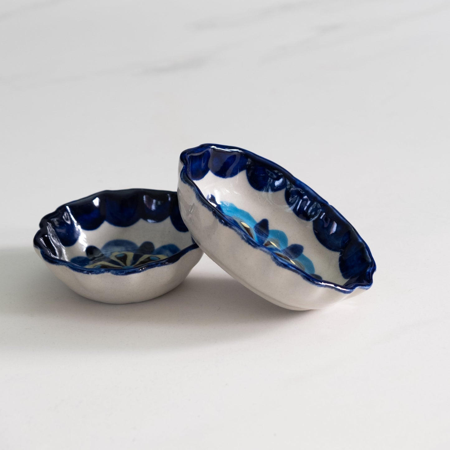 Blue and white painted round and oval tapas bowls.