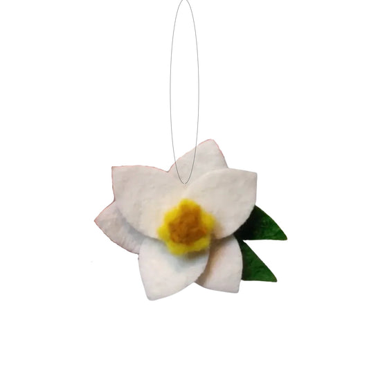 Felt ornament of a white and yellow daffodil flower with green leaves.