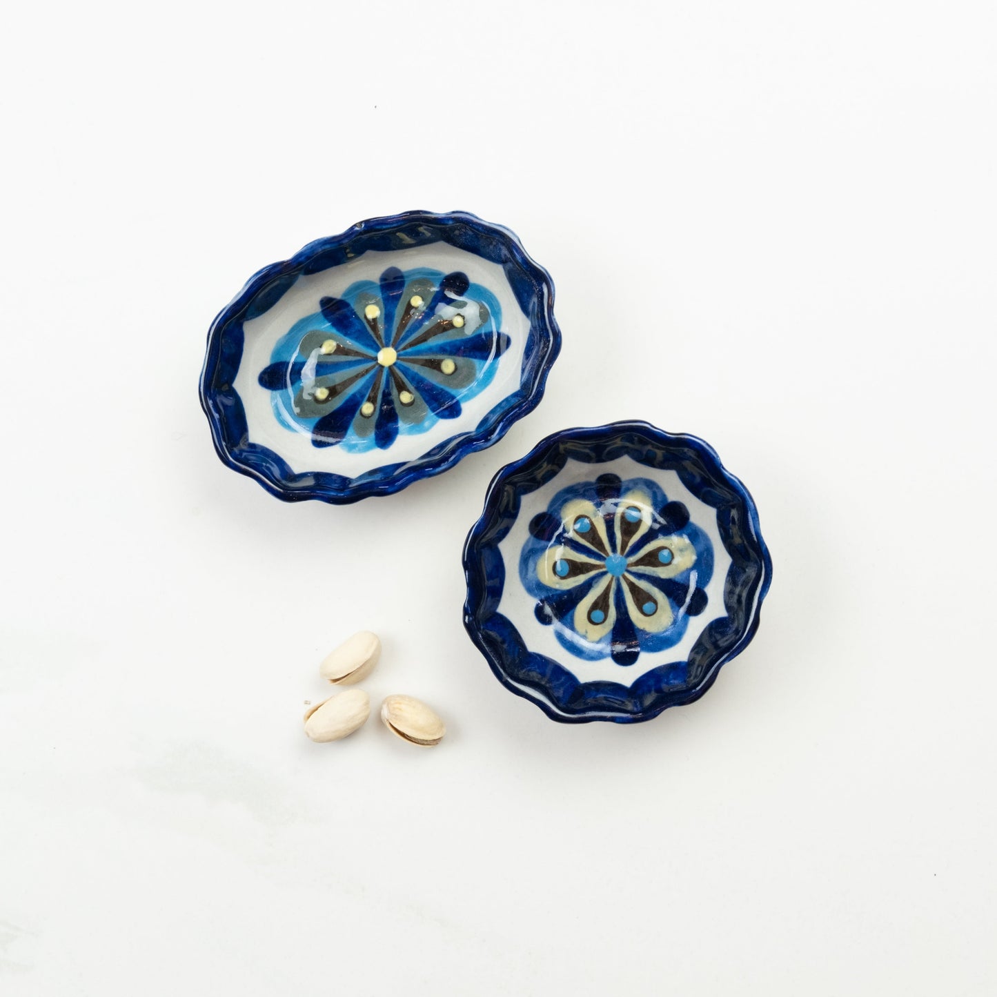 Blue and white painted round and oval tapas bowls.
