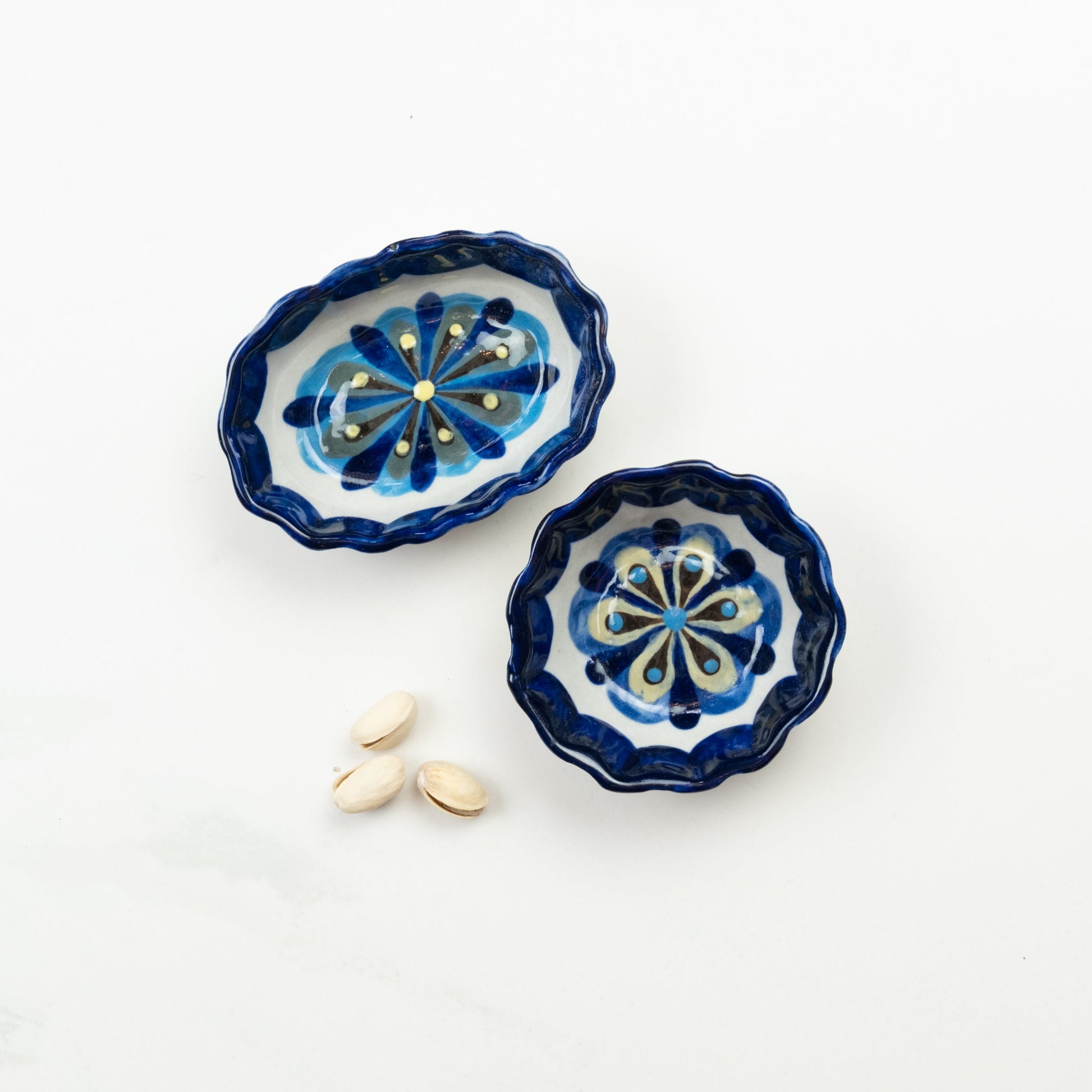 Blue and white painted round and oval tapas bowls.