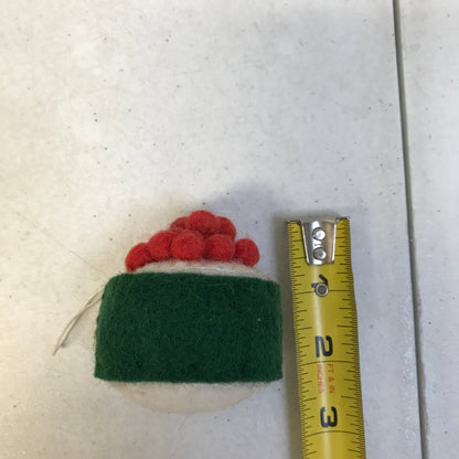Felt ornament of sushi with salmon roe on top next to measuring tape that shows it is 2 inches tall.