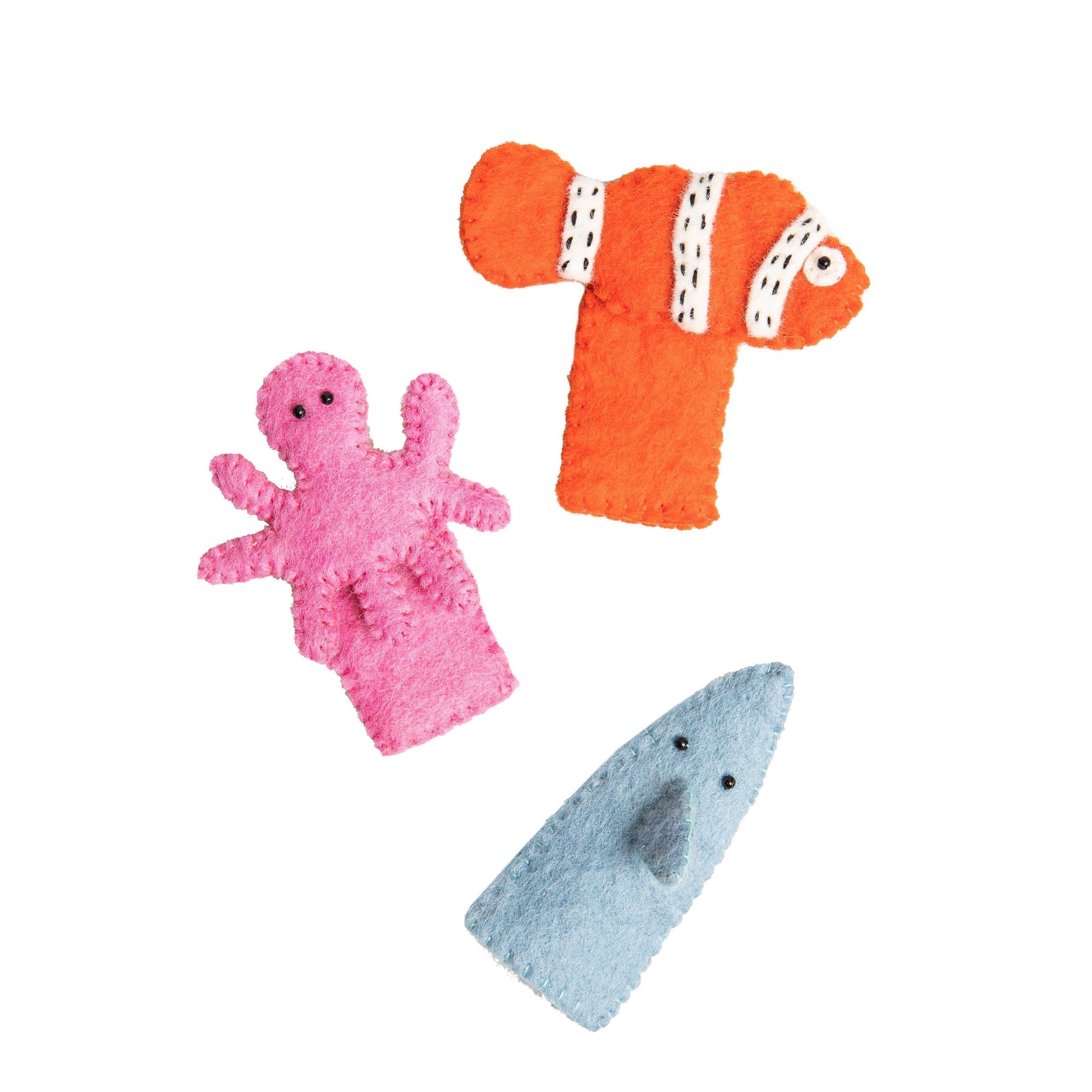 FClose up of finger puppets of an orange and white clown fish, a pink octopus, and a grey shark.