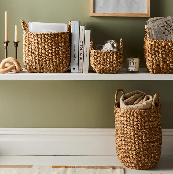 Collection of brown woven baskets on shelf.