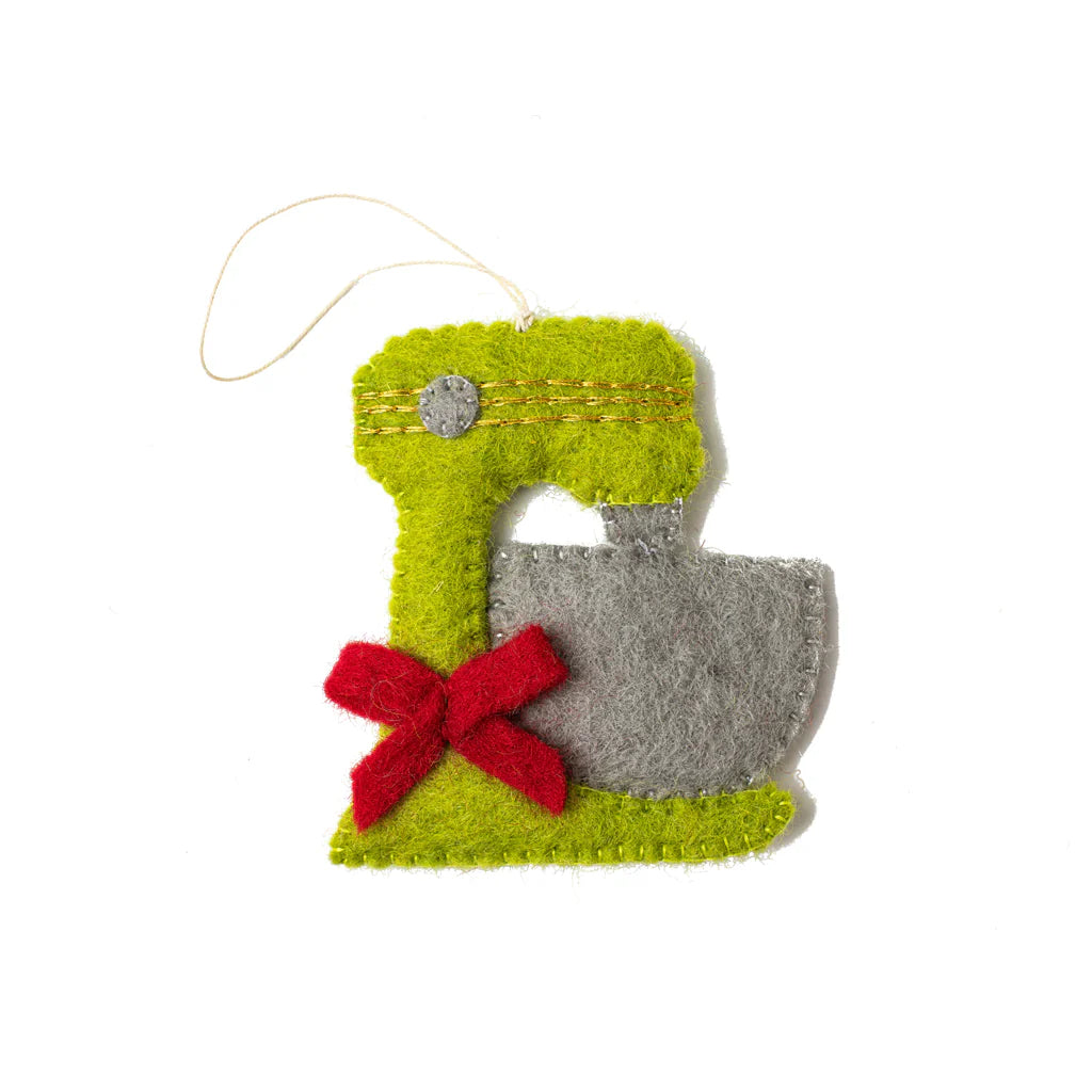 Felt ornament of a light green mixer with a red bow.