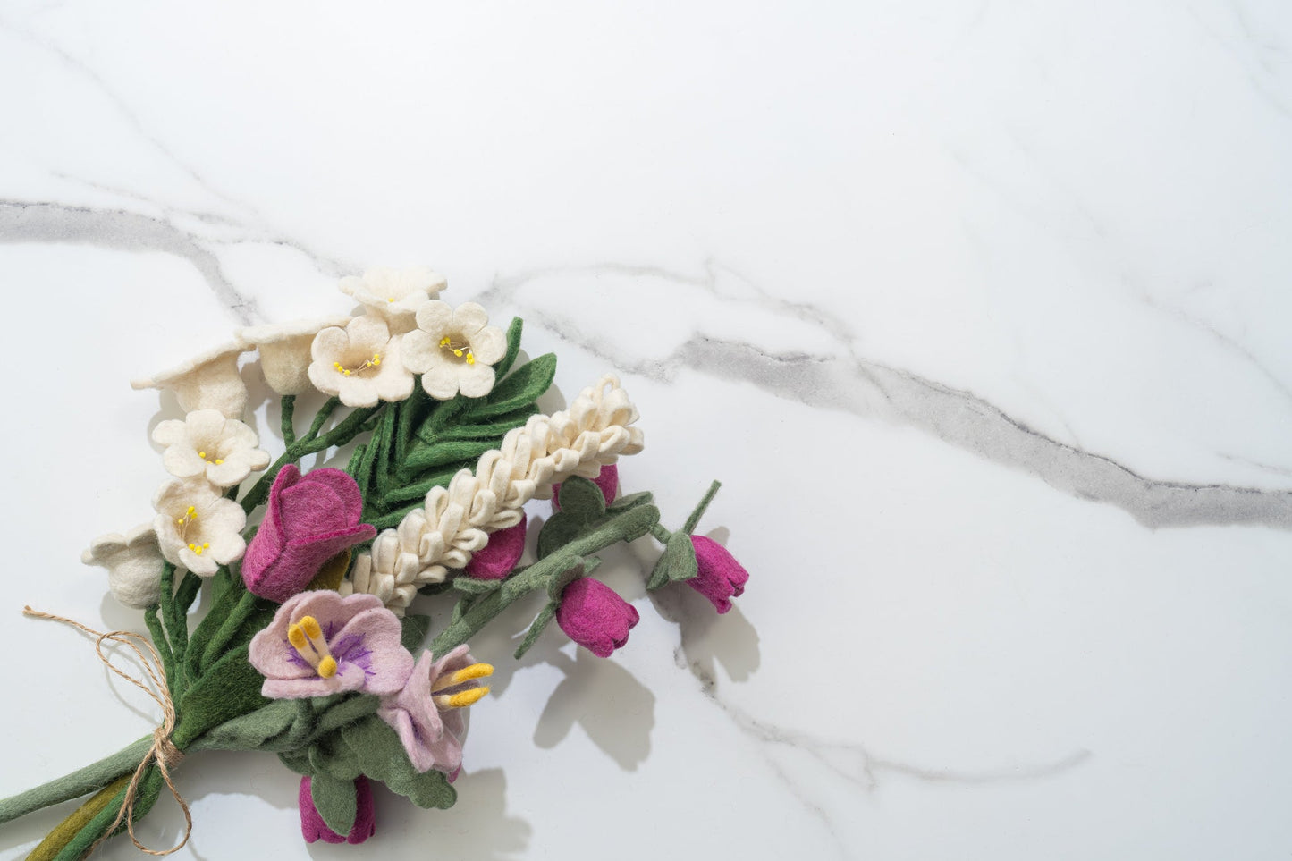 Bouquet of fair trade handmade felt flowers on a marble surface | Global Goods Partners