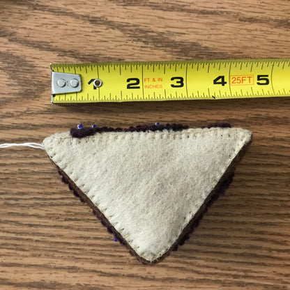 Close up of PB&J felt ornament measuring about 5 inches long.