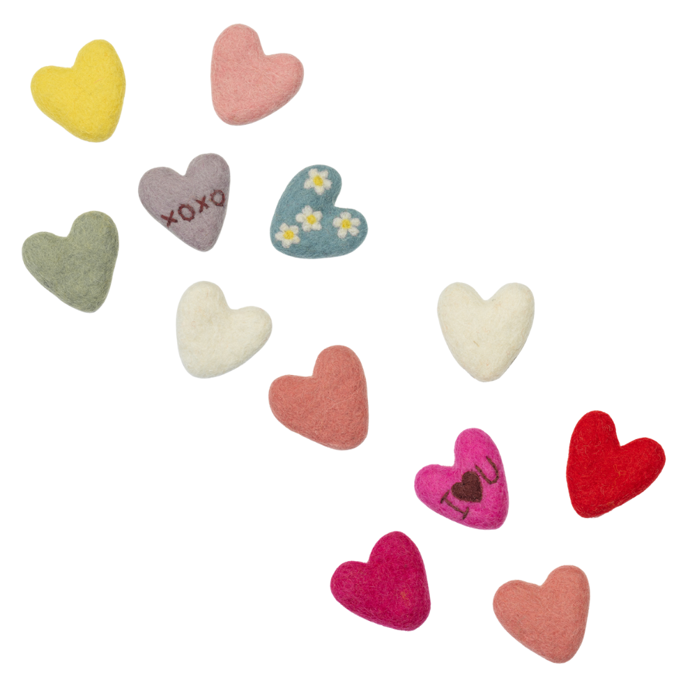 Fair trade felt colorful heart-shaped toys on a white background.