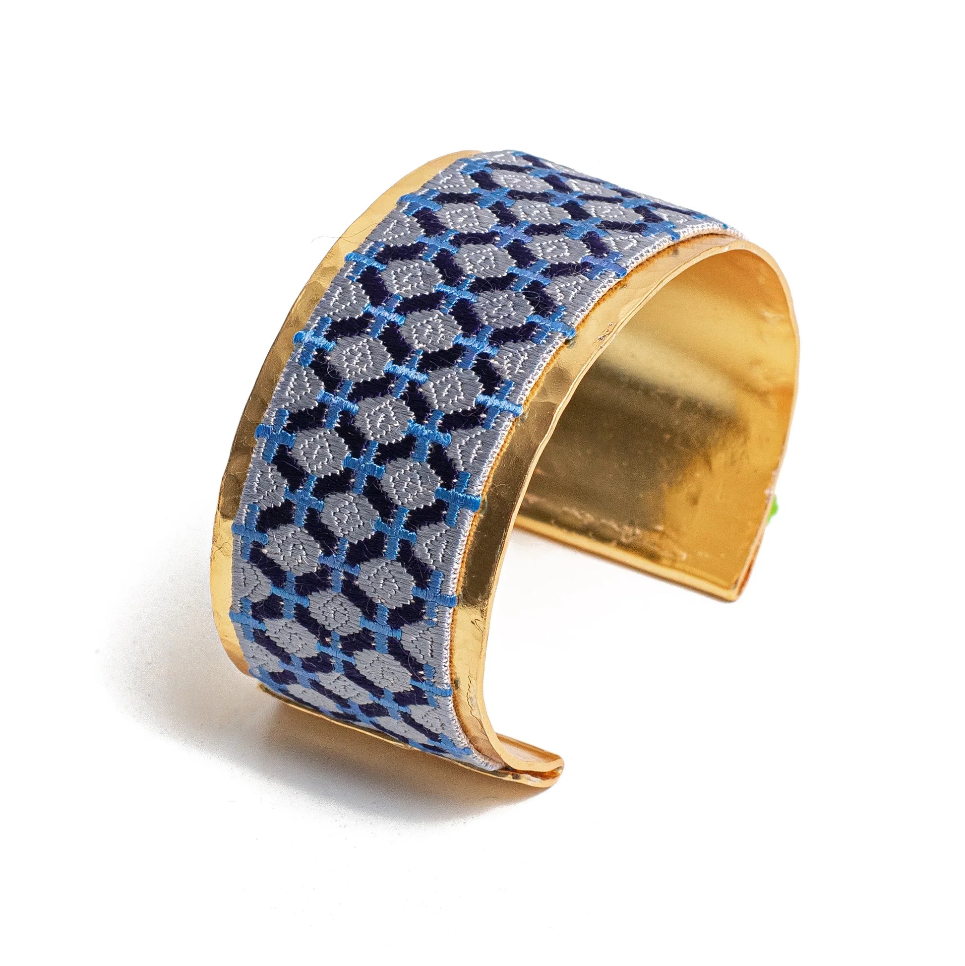 Gold plated cuff bracelet with blue embroidery artisan design.