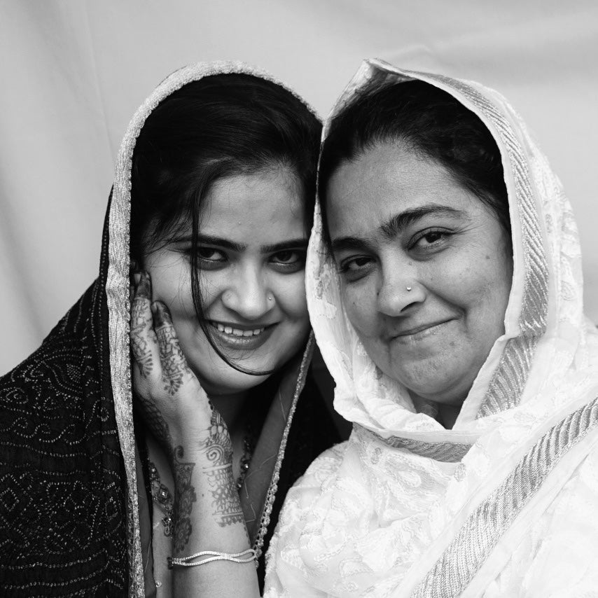 Black and white portrait of two women artisans.