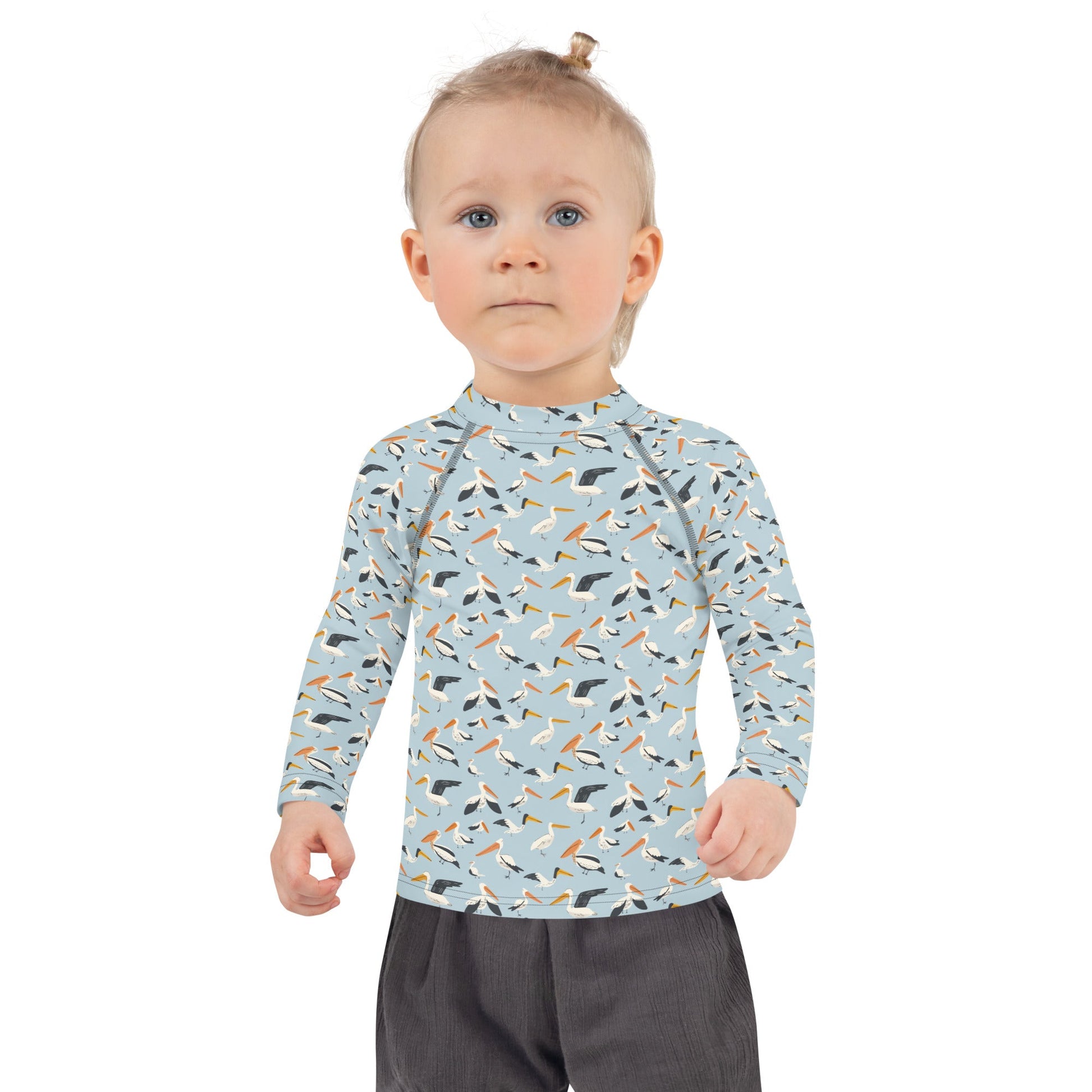 A pelican-themed rash guard for kids, crafted with lightweight, breathable fabric for fun in the water or sand.
