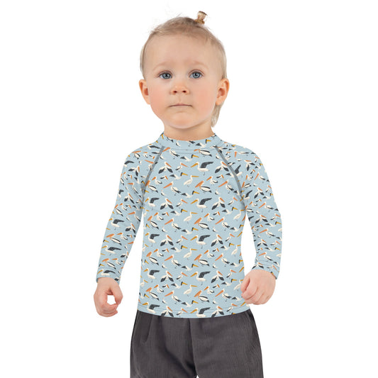 A pelican-themed rash guard for kids, crafted with lightweight, breathable fabric for fun in the water or sand.