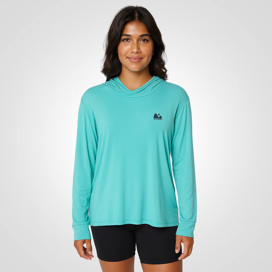 Woman wearing aqua bamboo sun shirt UPF ONE shirt and base layer.