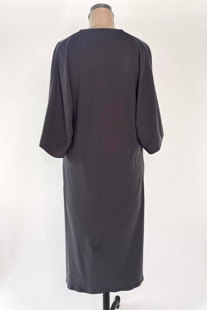 Back view of Knitted Orbis dress in iron color on mannikin.