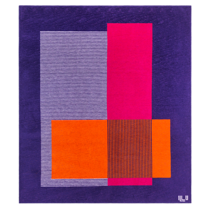 Blanket in bright purple, pink, and orange asymmetrical designs with purple background.