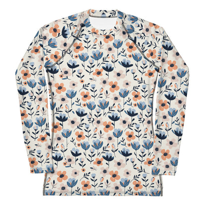 A women’s floral-print rash guard with colorful blooming flowers on a pastel background, shown from the front.