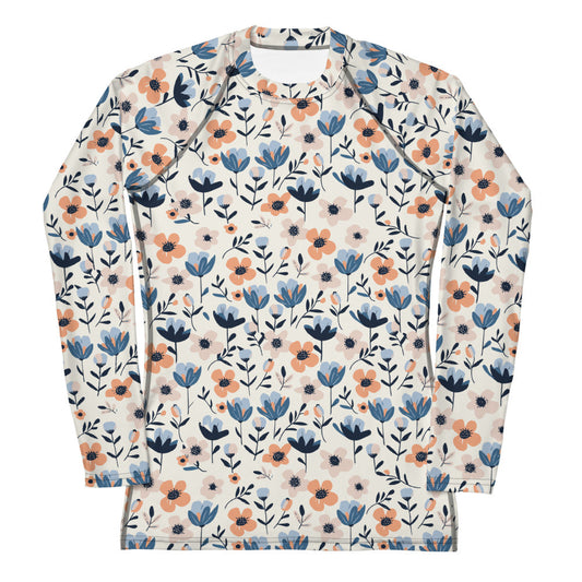 A women’s floral-print rash guard with colorful blooming flowers on a pastel background, shown from the front.