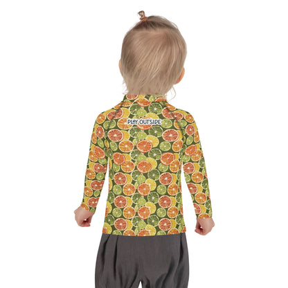 A child wearing a citrus-print rash guard with bright fruit patterns, offering full sun protection, shown from the back.