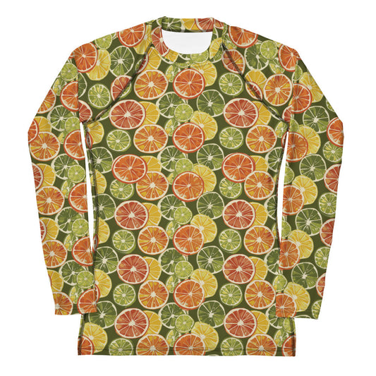 A vibrant citrus-themed rash guard for kids, featuring oranges and green leaves on a white background, shown from the front.