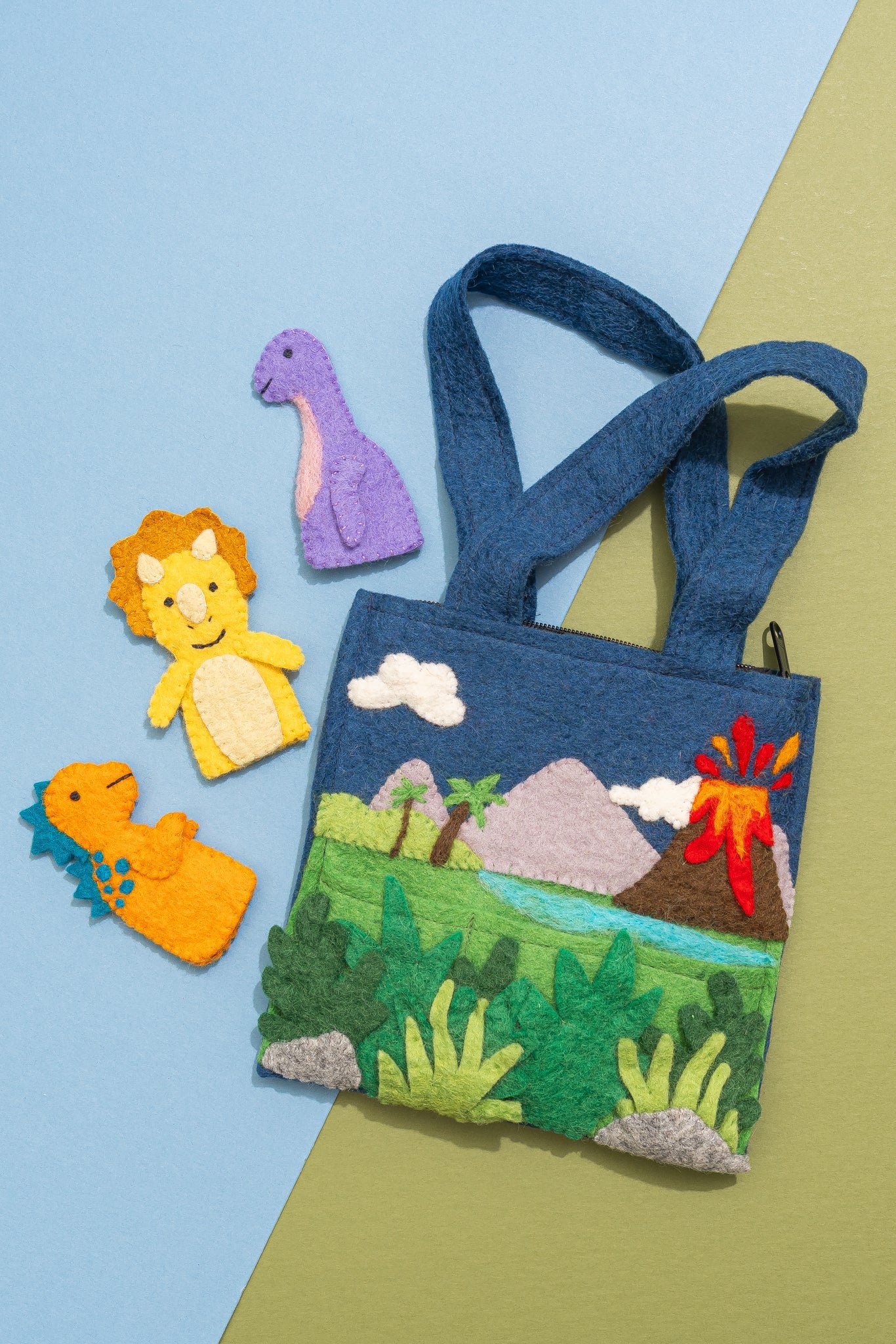 Children's felt bag with dinosaur puppets on a colorful background, handmade by women artisans in Nepal | Global Goods Partners