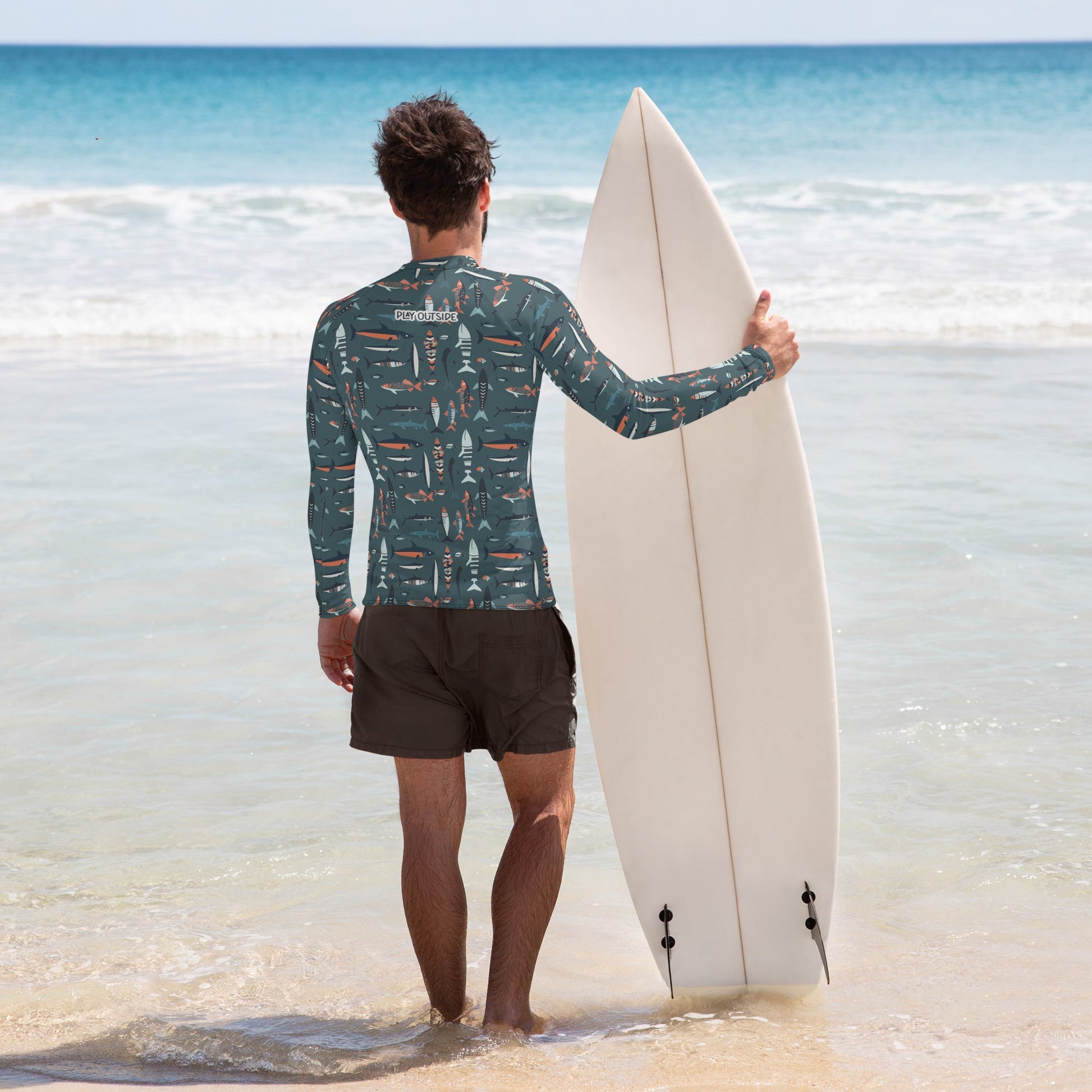 A men’s rash guard featuring vibrant fish patterns, made with sustainable, moisture-wicking fabric for outdoor adventures. Family matching
