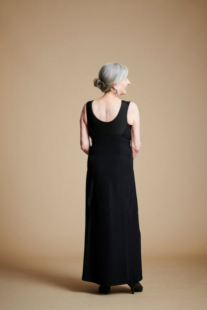 Back view of woman wearing long black dress with scoop back.