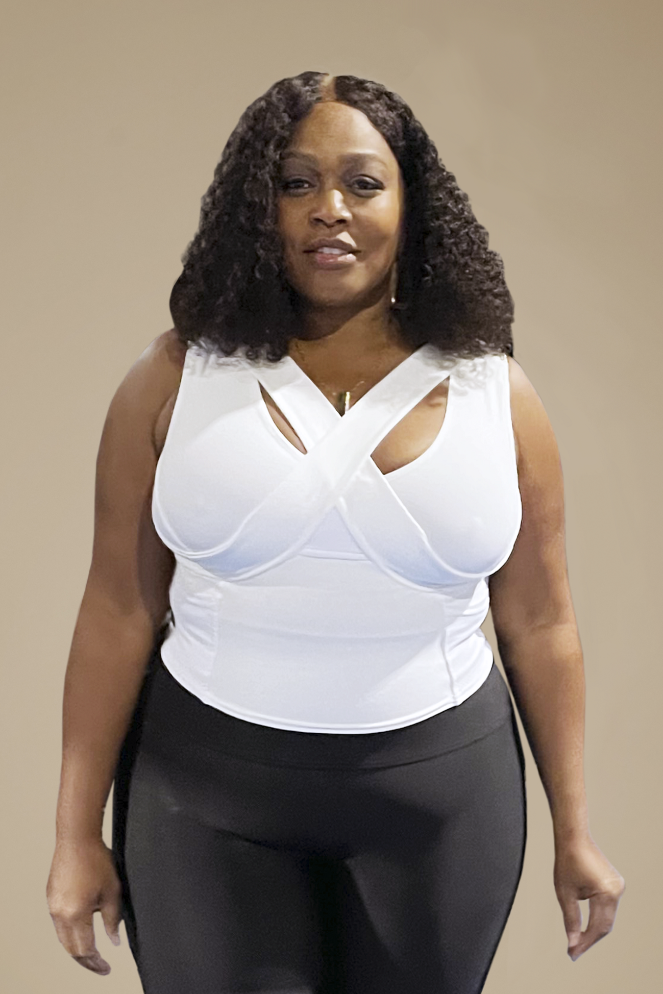 Woman wearing white waist length crop top and black exercise pants.