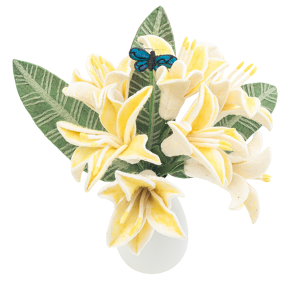 Handmade felt easter lily flowers, green leaves, and a blue butterfly arranged in a white vase on a white background, all handmade by women artisans | Global Goods Partners