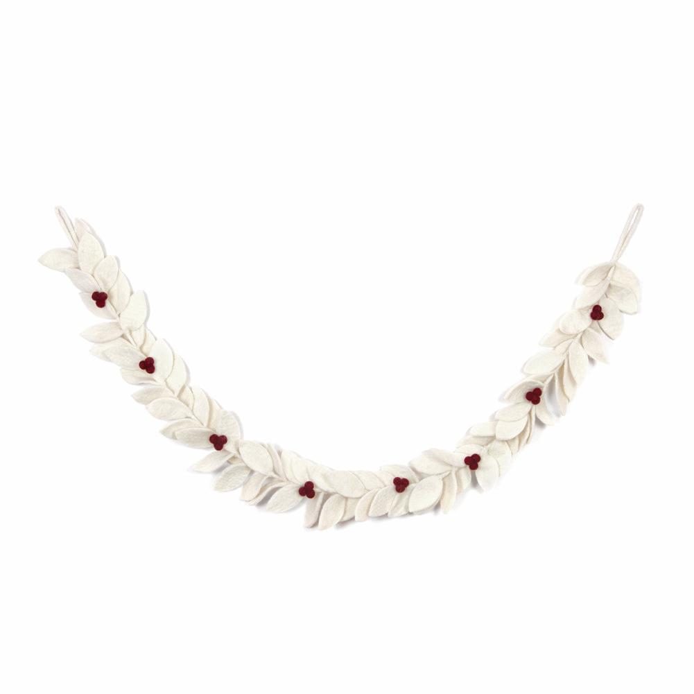 Felt garland with white leaves with red berries hanging on wall.