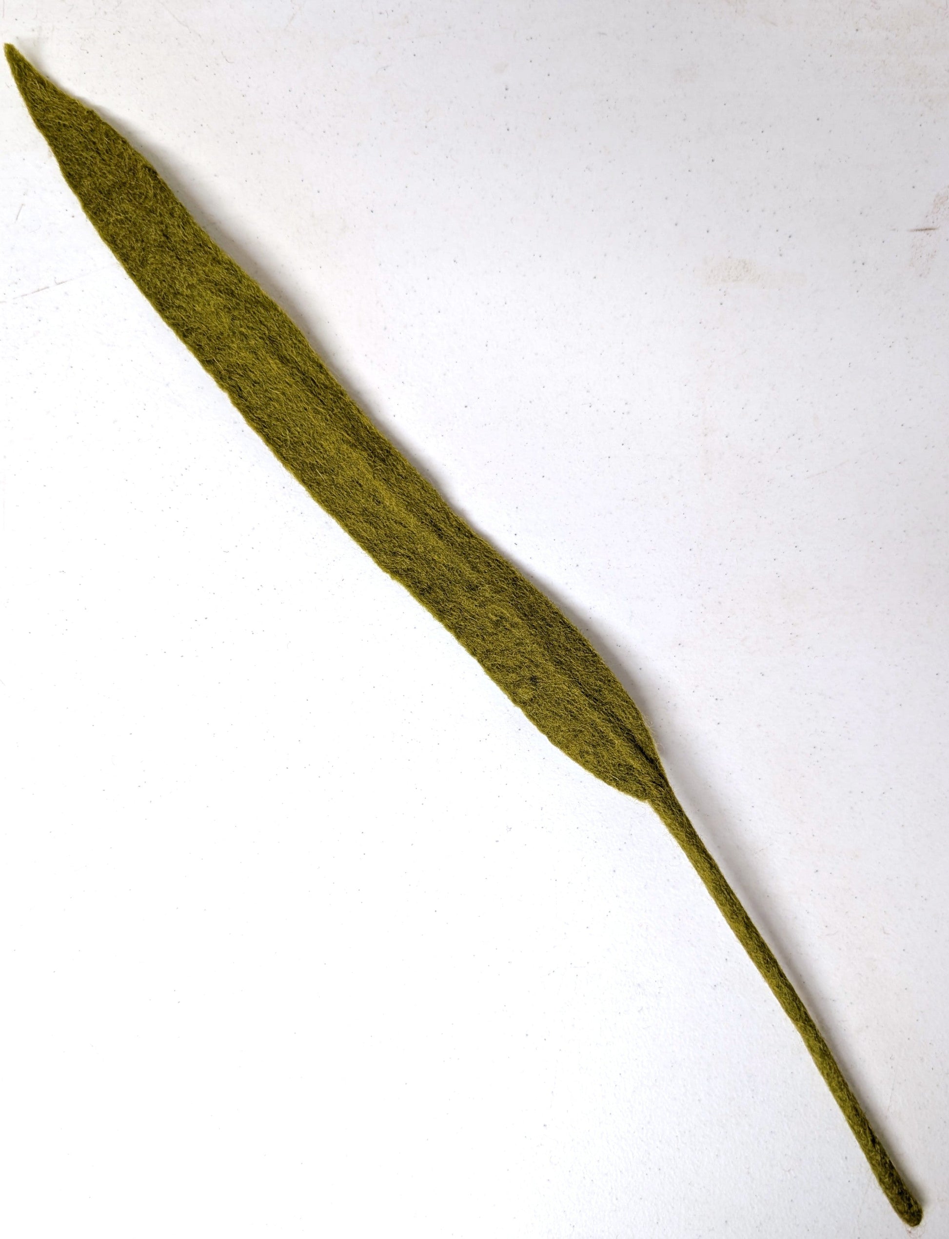 Long, narrow fair trade felt green leaf on a white background. Handmade by women artisans in Nepal | Global Goods Partners