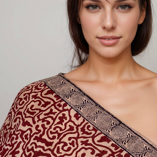 Front view closeup of woman with red, natural, black stole draped over right shoulder.