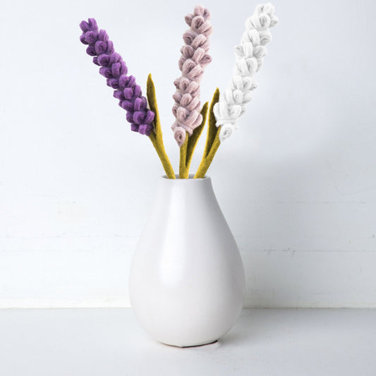 Felt Lavender flowers in purple, light purple, and white in a white vase.