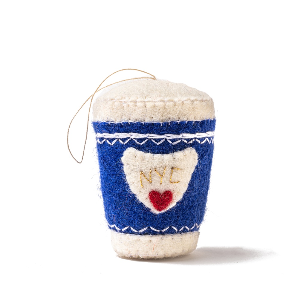 Felt ornament of a coffee cup with a blue sleeve that has NYC and a red heart on it.