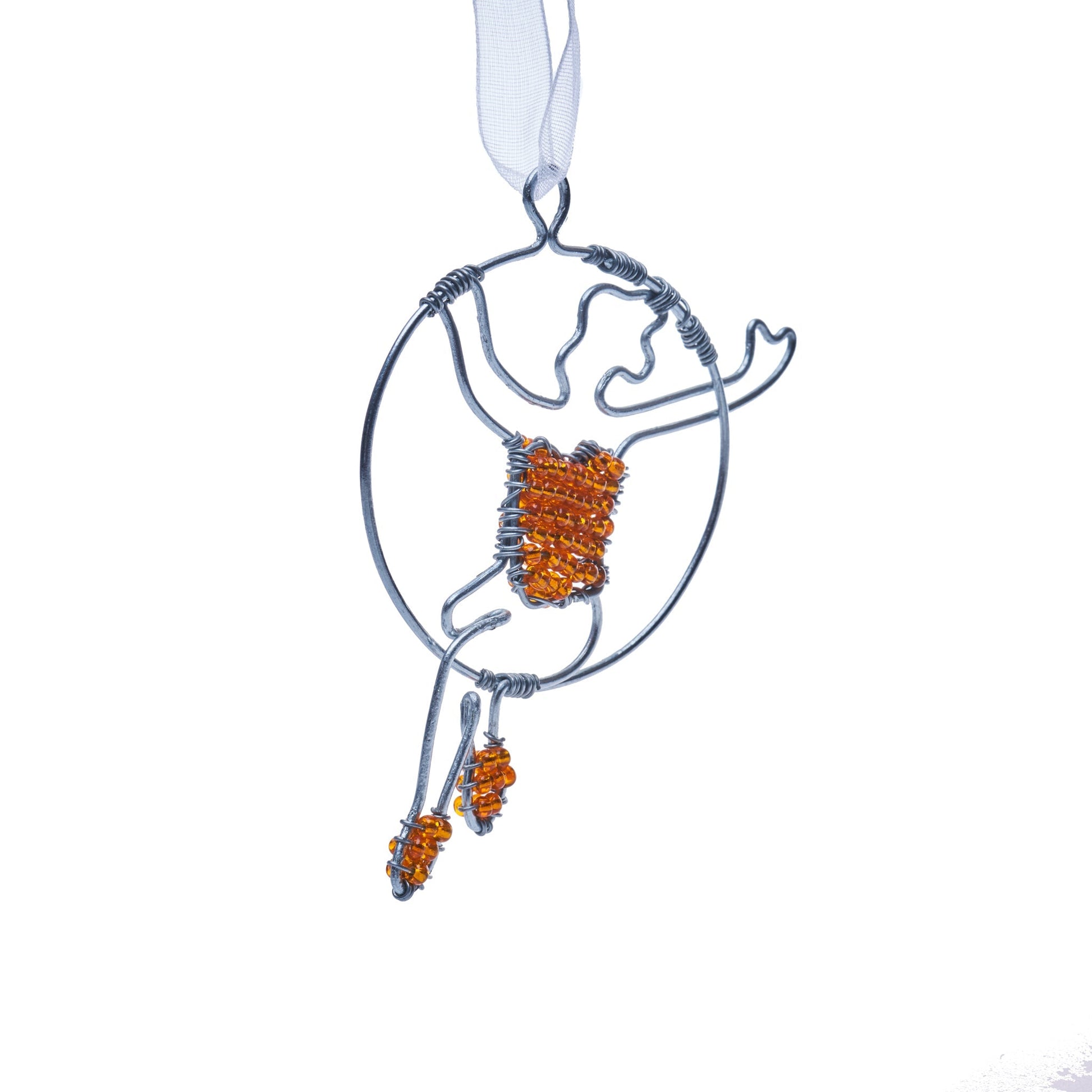 Wire and bead ornament of a woman swinging on a circus/aerial hoop in a red top and red shoes.