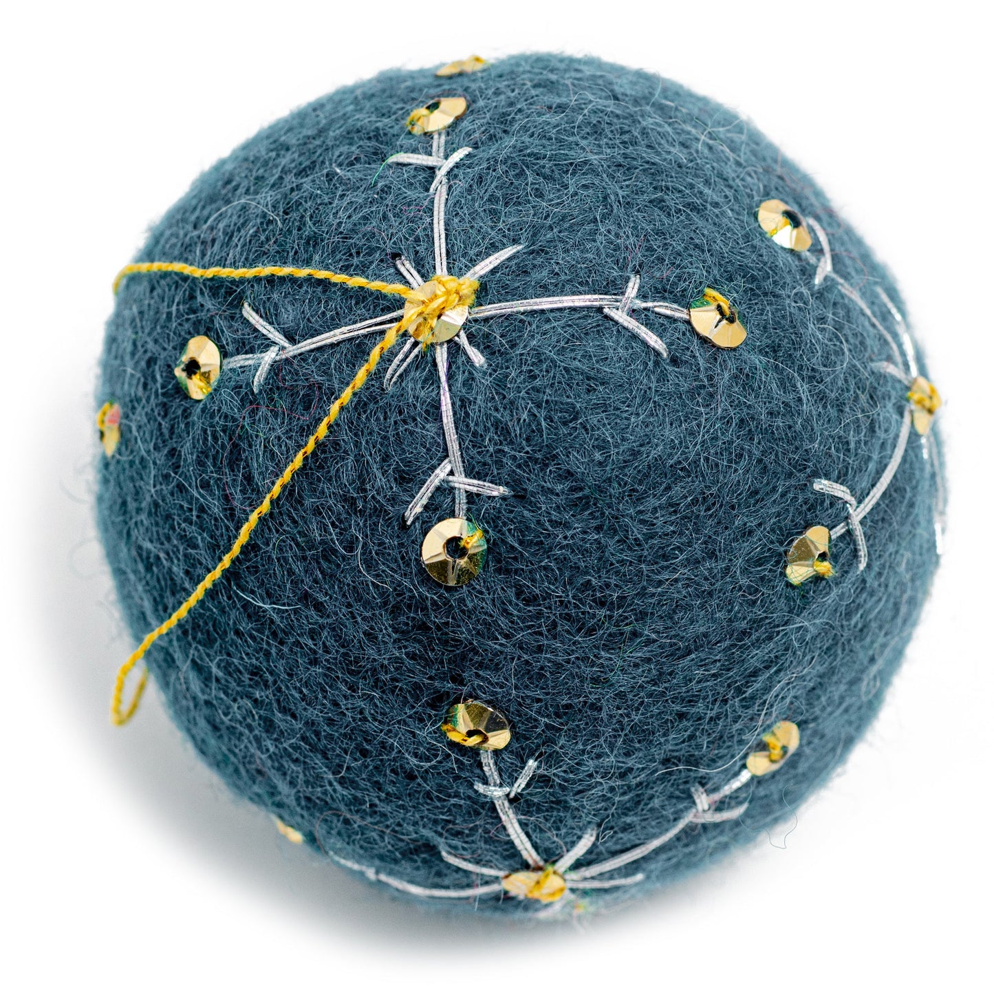 A dark blue round felt ornament with white embroidery and gold sequin designs.