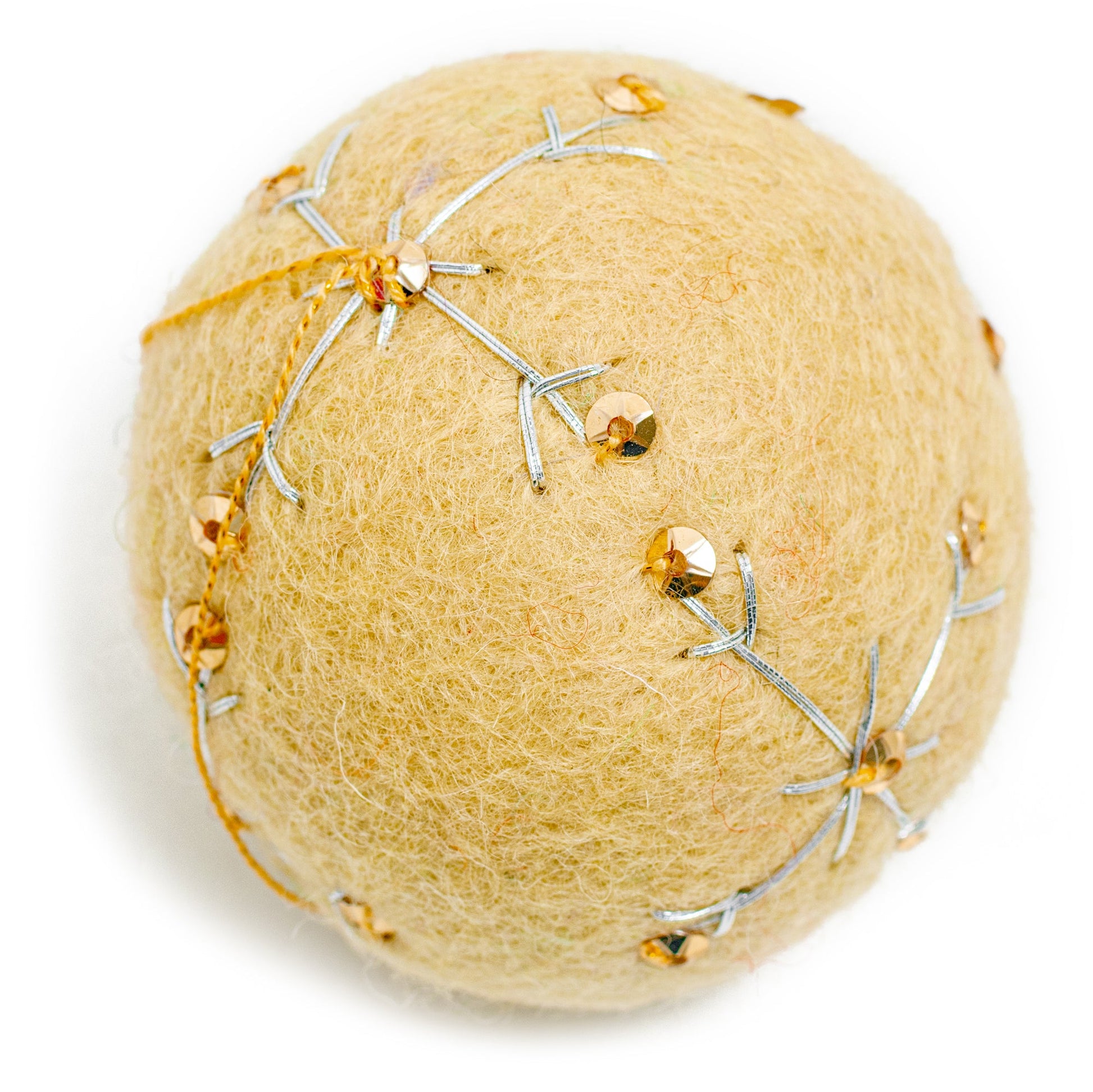 A yellow round felt ornament with white embroidery and gold sequin designs.