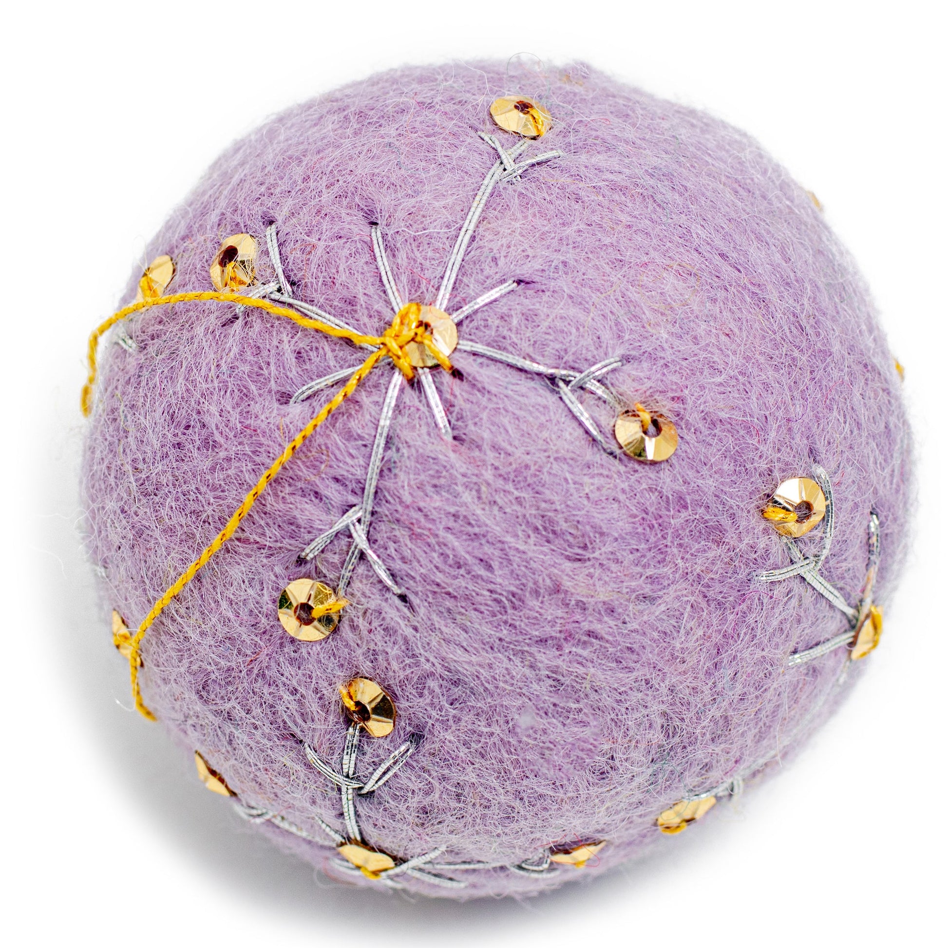 A purple round felt ornament with white embroidery and gold sequin designs.