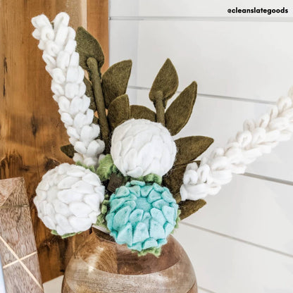 White felt Lavender flowers in a vase with blue and white felt flowers.