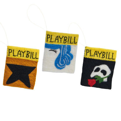 Felt ornaments of playbills for the Broadway shows Hamilton, Hairspray, and The Phantom of the Opera.