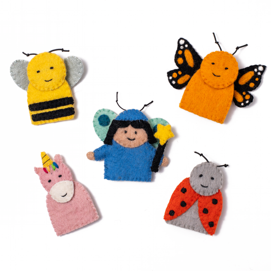 Scattered finger puppets of a pink unicorn, a blue fairy, an orange Monarch Butterfly, a Ladybug and a yellow Bumble Bee.