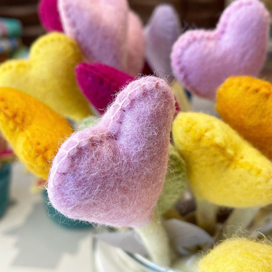 Felt heart accent stems in pink, yellow, and orange.