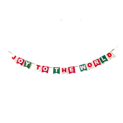Felt garland spelling out Joy to the World in red and white letters on small dovetail flags in white, red, and green.