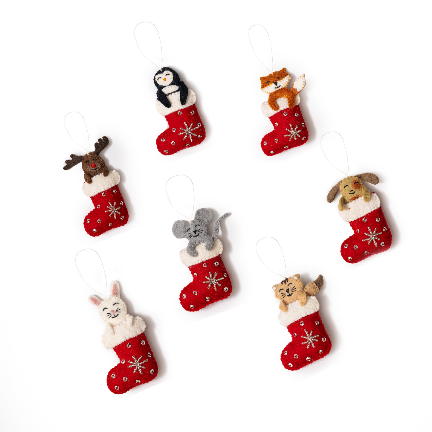 Scattered felt ornaments of various animals sticking out of red and white Christmas stockings.
