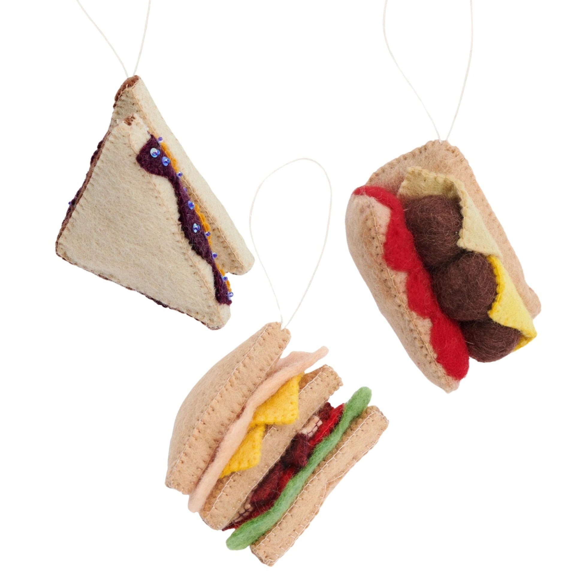Felt ornaments of sandwiches. A triangle cut PB&J, a turkey club and a meatball sub.