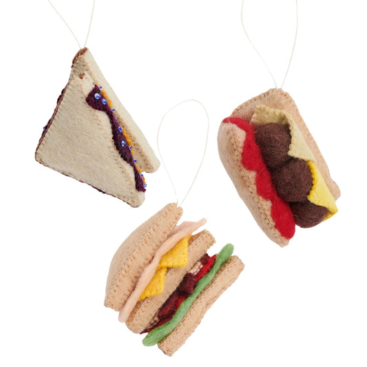Felt ornaments of sandwiches. A triangle cut PB&J, a turkey club and a meatball sub.