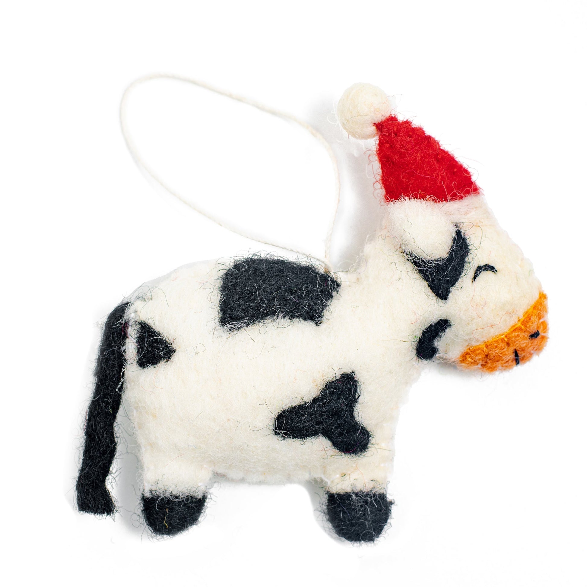 Felt ornament of a cow in a Santa hat.