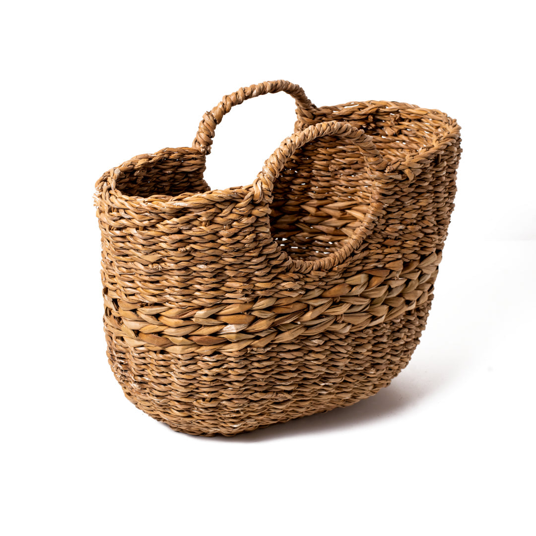 Angled view of brown woven basket with round handles.